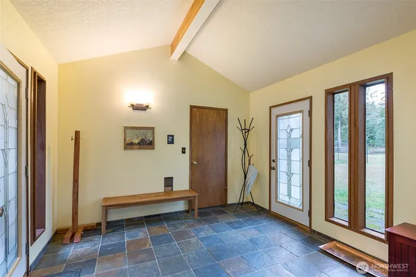 a spacious bedroom with a bed and a window