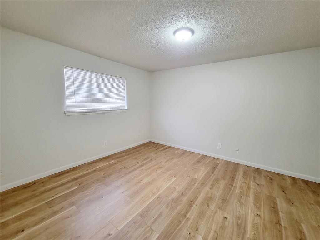 735 Arrowhead Circle Garland, TX 75043 - Photo 16 of 20 a view of empty room with wooden floor