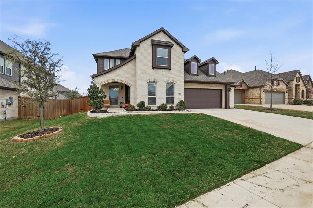 View of front of house with concrete driveway, an attached garage, and brick siding