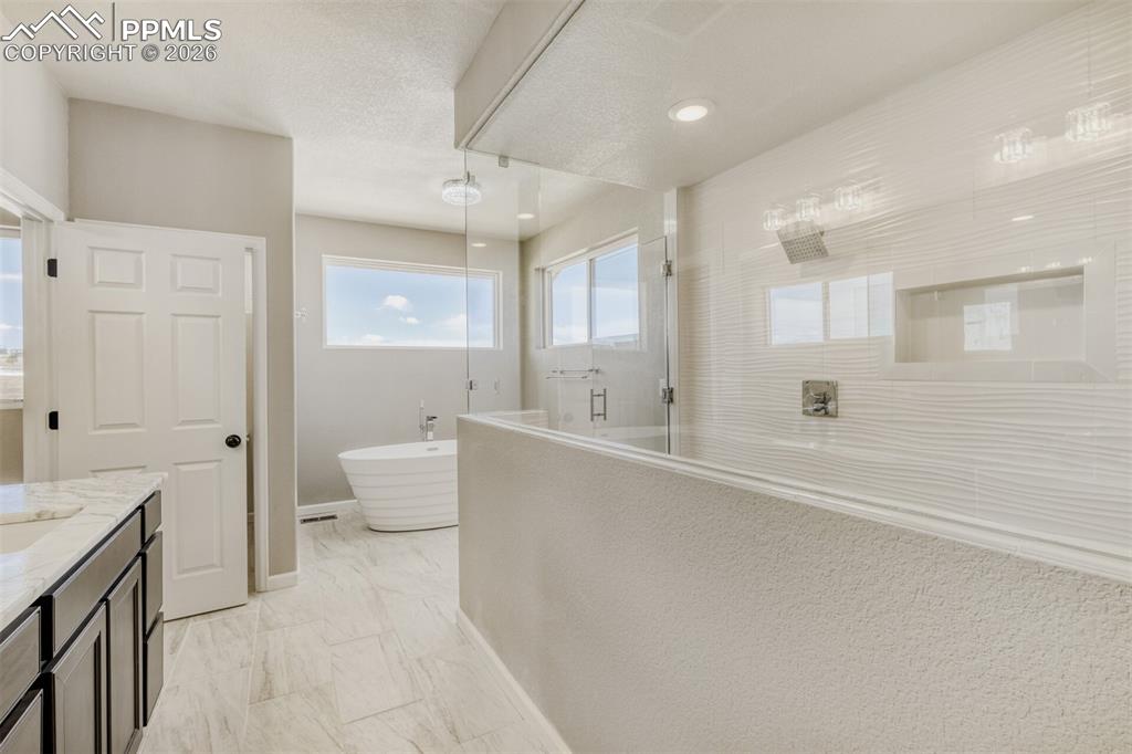 13680 Woodlake Road Elbert, CO 80106 - Photo 23 of 47 a bathroom with a tub sink and mirror