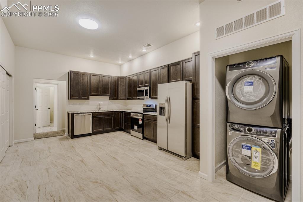 13680 Woodlake Road Elbert, CO 80106 - Photo 25 of 38 a kitchen with stainless steel appliances a stove a refrigerator and a sink
