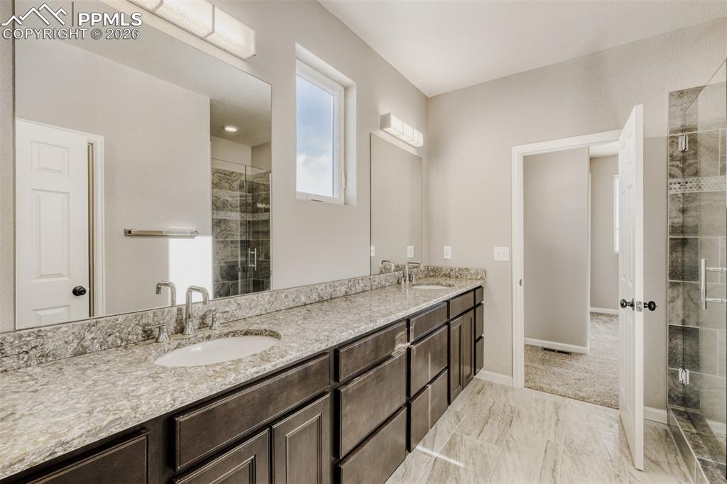 13680 Woodlake Road Elbert, CO 80106 - Photo 27 of 47 a bathroom with a granite countertop sink and a mirror