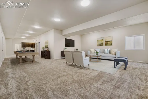 a view of an empty room with a kitchen