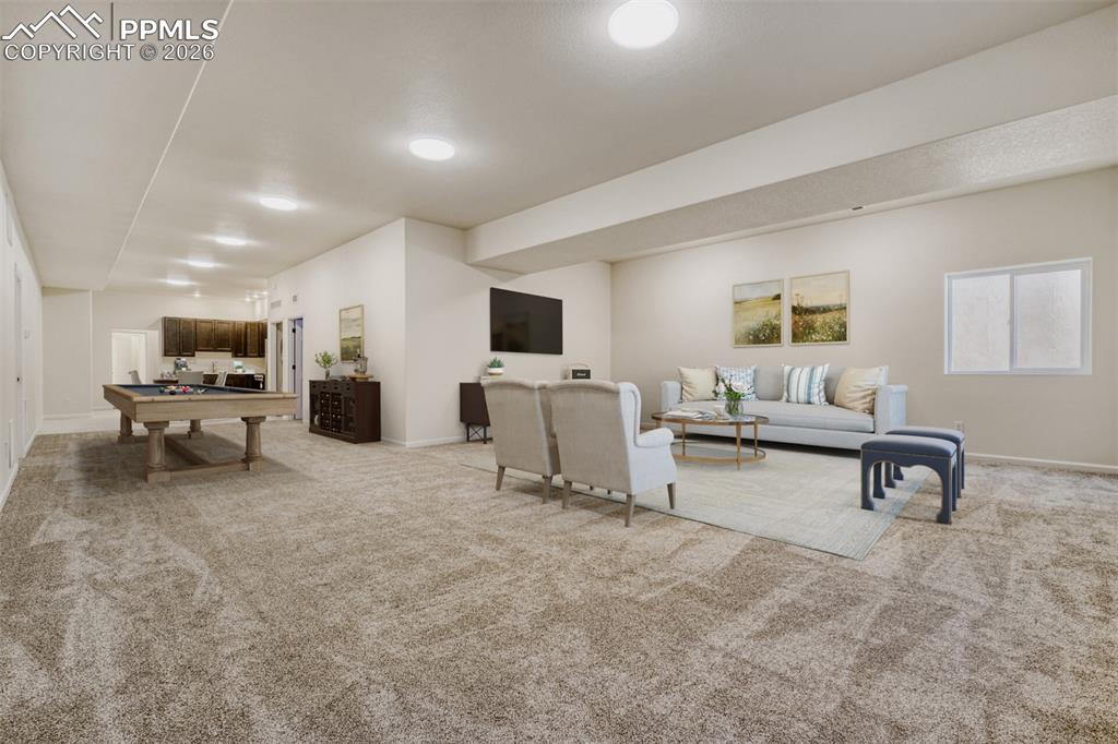 13680 Woodlake Road Elbert, CO 80106 - Photo 31 of 47 a living room with furniture and a flat screen tv