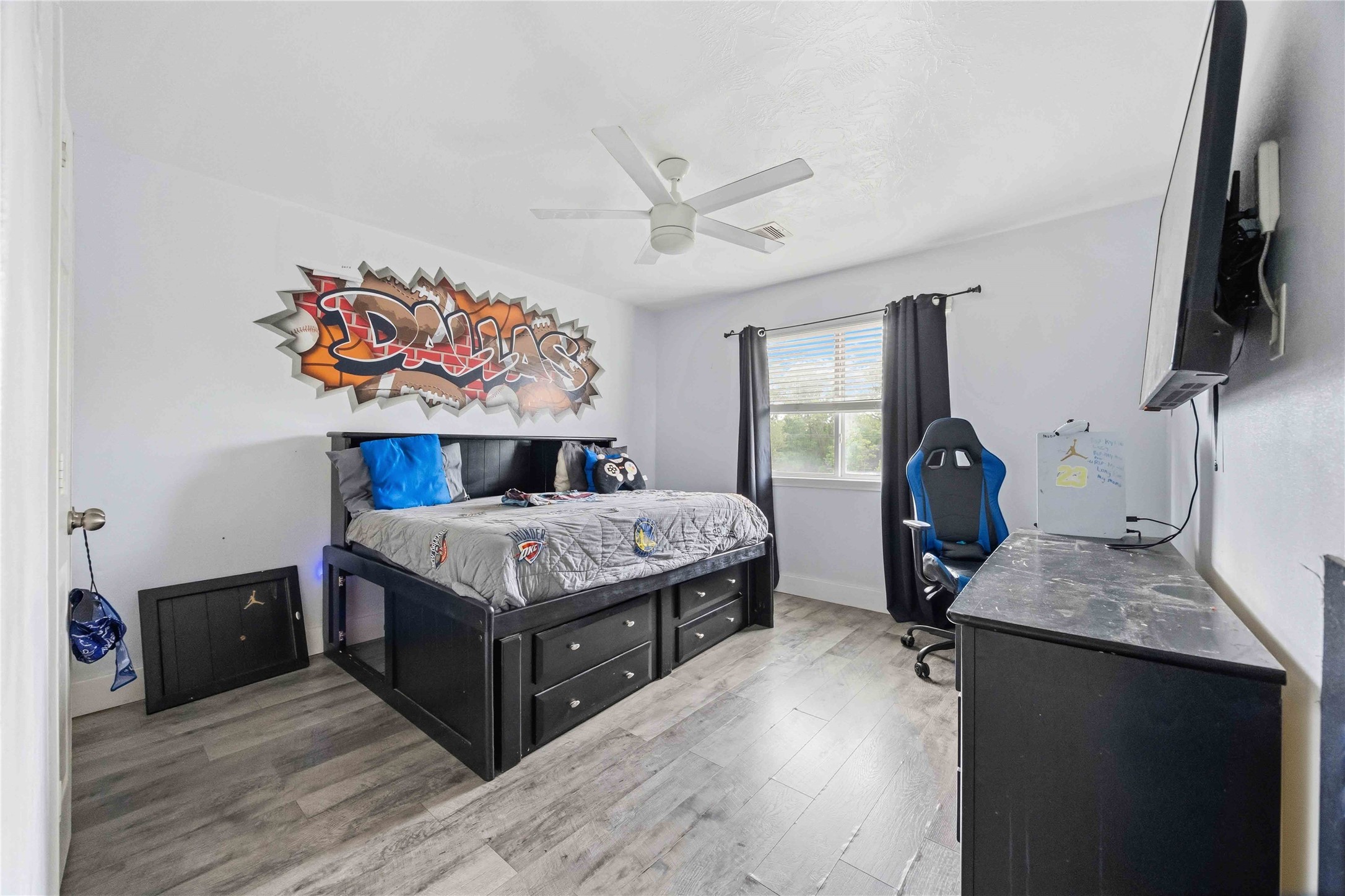 3538 Maris Way Humble, TX 77338 - Photo 17 of 24 Spacious bedroom featuring wood-look flooring, ceiling fan, and plenty of natural light from a large window. Functional layout offers room for a full bedroom set plus study or hobby space.