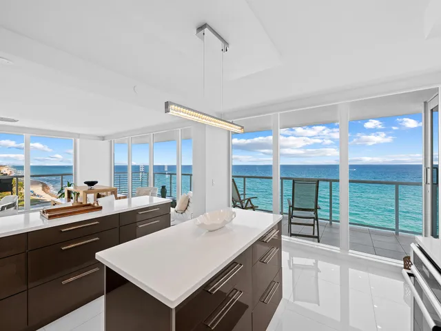 a kitchen with sink a large window and a counter top space
