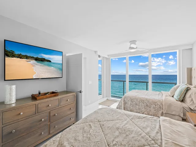 a bedroom with a bed and balcony view