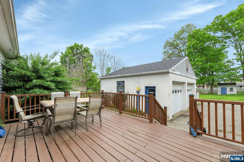 17 Butler Place Wanaque, NJ 07420 - Photo 6 of 28 a view of a roof deck with table and chairs and wooden floor