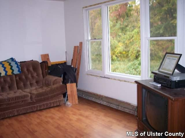 215 South Riverside Road Highland, NY 12528 - Photo 4 of 4 a living room with furniture and a window
