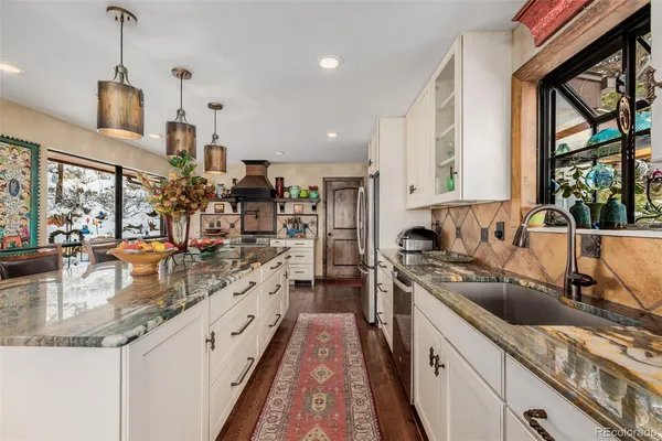 a kitchen with sink stove and cabinets