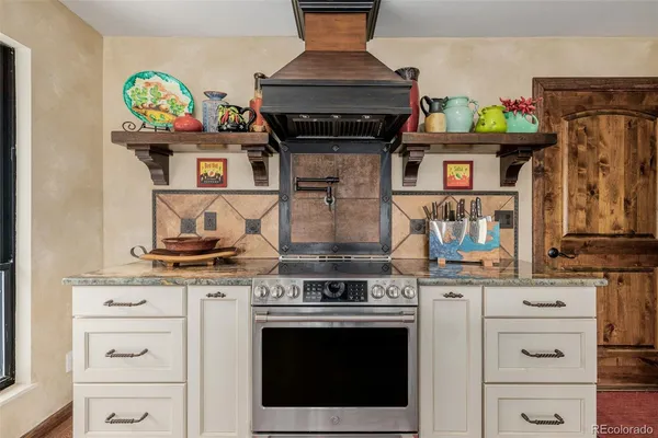 a stove top oven sitting inside of a kitchen