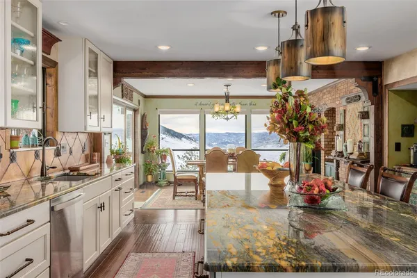 a kitchen with stainless steel appliances granite countertop a sink stove and cabinets