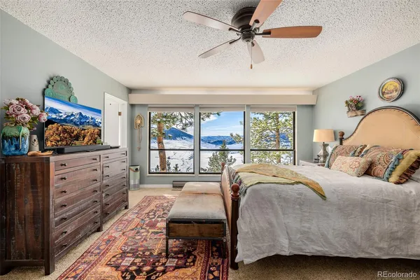 a bedroom with a large bed and a window