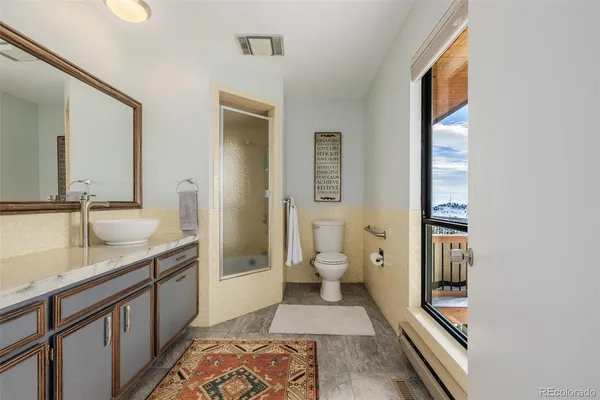 a spacious bathroom with a granite countertop sink and a mirror