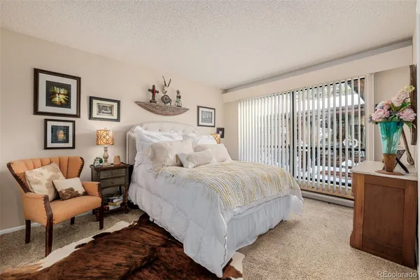 a spacious bedroom with a bed and a couch