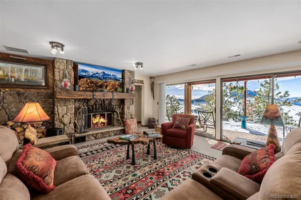 a living room with furniture and a floor to ceiling window