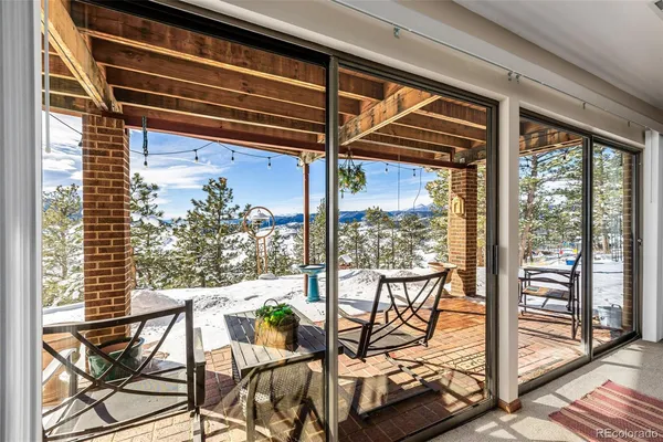 a view of a room with wooden floor and outdoor seating