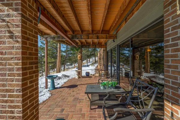 a building outdoor space with patio furniture and potted plants