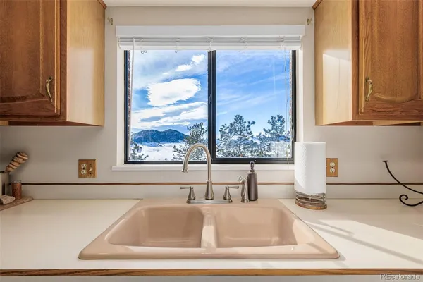 a bathroom with mirror and window