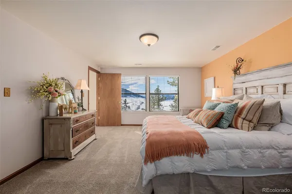a bedroom with two beds and a potted plant