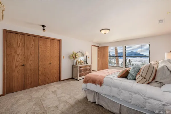 a bedroom with a large bed and a window