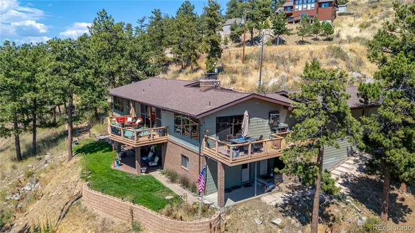 an aerial view of a house with swimming pool and a yard