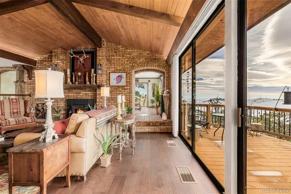 a view of a living room with furniture and wooden floor