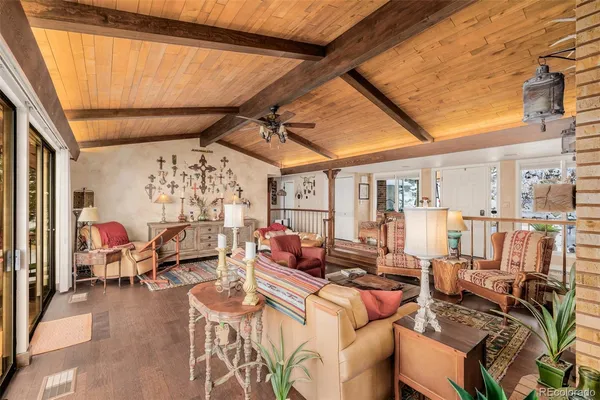 a living room with lots of furniture and a large window