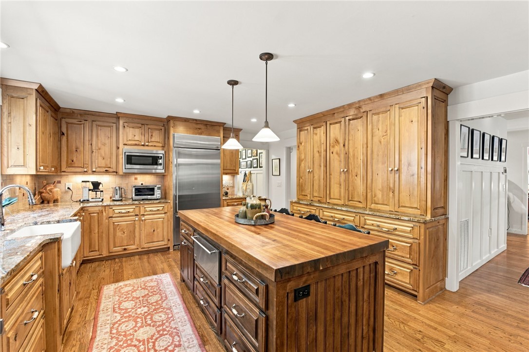 604 Ridgecrest Drive Clemson, SC 29631 - Photo 21 of 50 Rich wood cabinetry paired with a coordinating butcher block island grounds this spacious kitchen design.