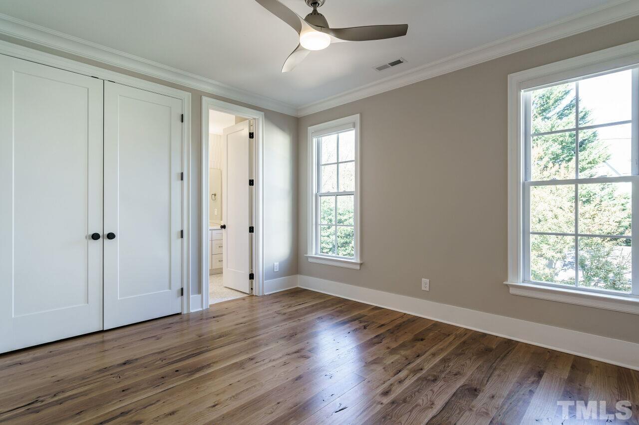 404 East Whitaker Mill Road Raleigh, NC 27608 - Photo 44 of 63 a view of an empty room with wooden floor and a window
