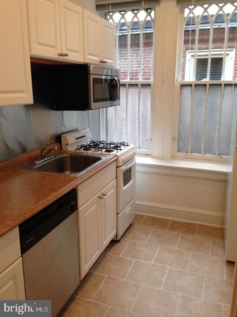 1209 Spruce Street, Unit 3R Philadelphia, PA 19107 - Photo 1 of 5 a kitchen with a sink and cabinets
