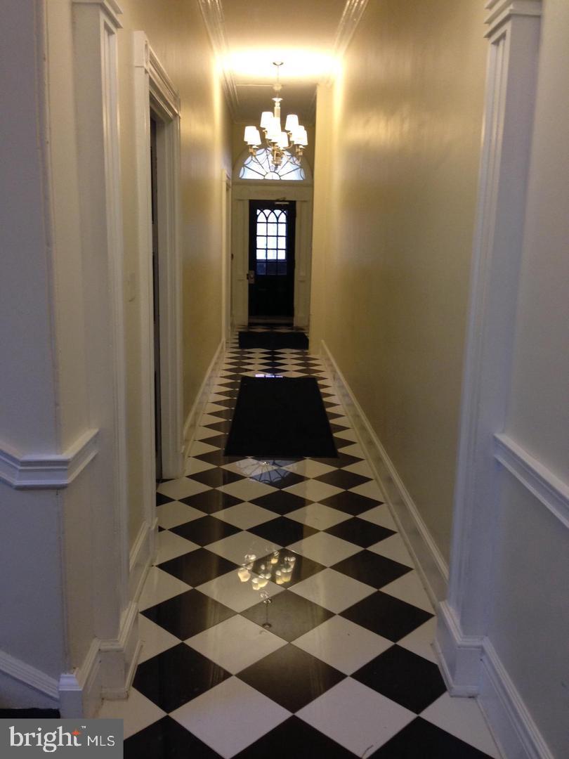 1209 Spruce Street, Unit 3R Philadelphia, PA 19107 - Photo 2 of 5 a hallway with a black and white checkered floor