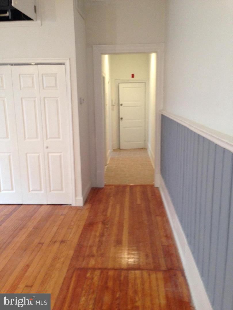 1209 Spruce Street, Unit 3R Philadelphia, PA 19107 - Photo 5 of 5 a view of a hallway with wooden floor