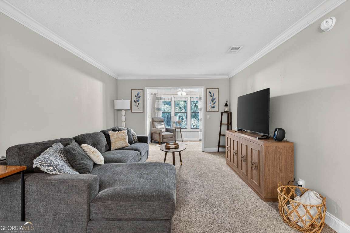 2514 Demere Road, Unit 7 St. Simons, GA 31522 - Photo 12 of 22 a living room with furniture and a flat screen tv