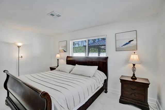 a bedroom with a bed and a lamp on table