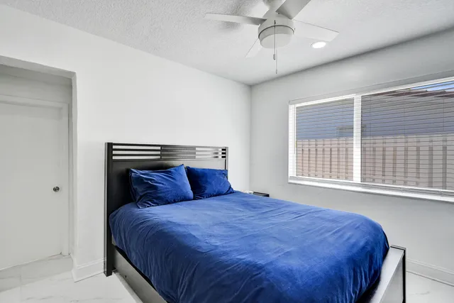 a bedroom with a bed and a window