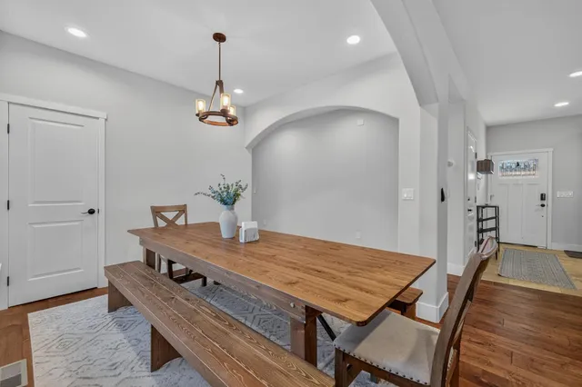 a bathroom with a granite countertop bathtub sink mirror vanity and toilet