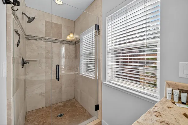 a view of a balcony with wooden floor and fence