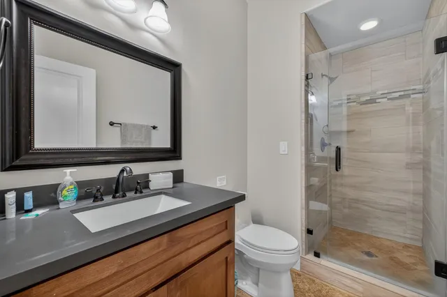 a kitchen with kitchen island granite countertop a sink a counter top space and living room view