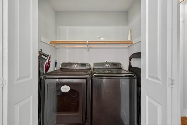 a bedroom with a bed lamp and window