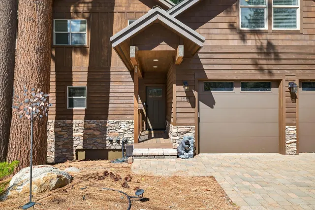 a kitchen with stainless steel appliances granite countertop a kitchen island a stove a table and chairs