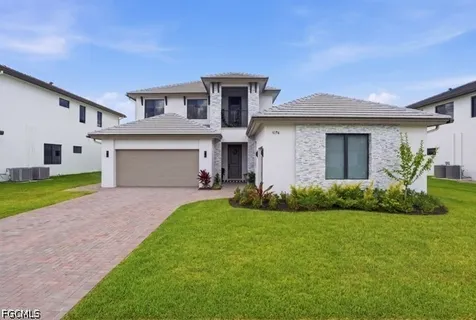 a front view of a house with a garden and yard