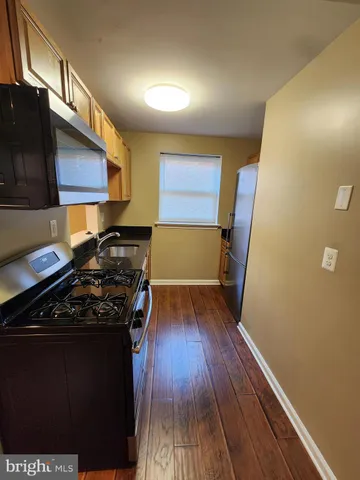 a kitchen with wooden floors and a stove