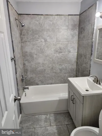 a bathroom with a sink a toilet and a bathtub