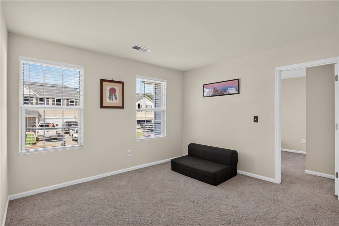 1081 Edenbrooke Circle Anderson, SC 29621 - Photo 35 of 46 A versatile room bathed in natural light, featuring plush carpeting and multiple windows.