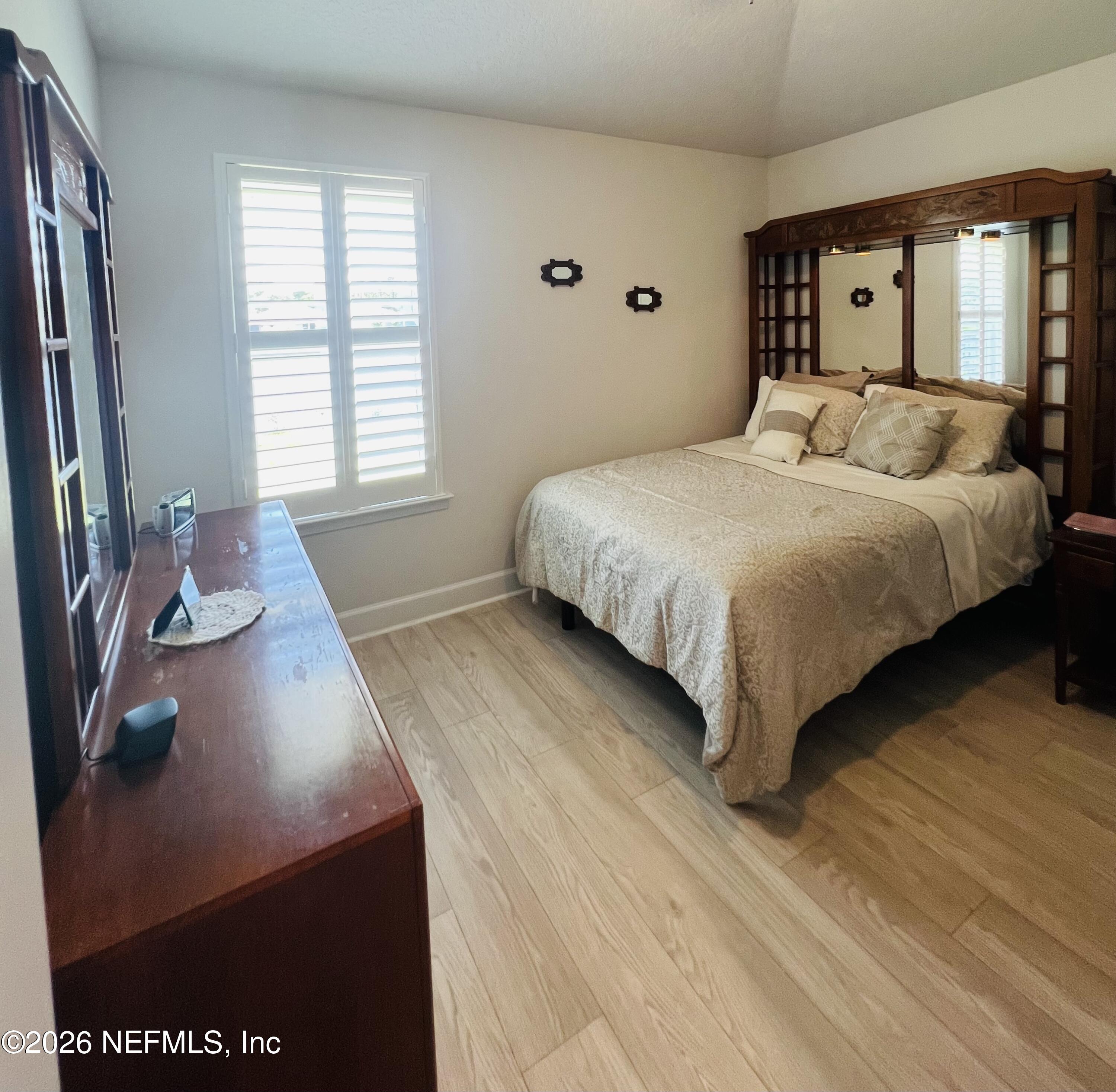 2 Rivertown Road Palm Coast, FL 32137 - Photo 62 of 80 a bedroom with a bed and a dresser with mirror