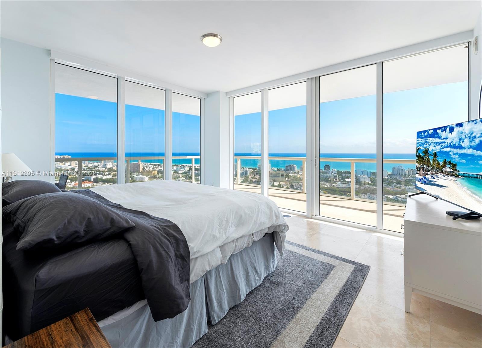 450 Alton Road, Unit 3010 Miami Beach, FL 33139 - Photo 17 of 66 a bedroom with a large bed and a large window