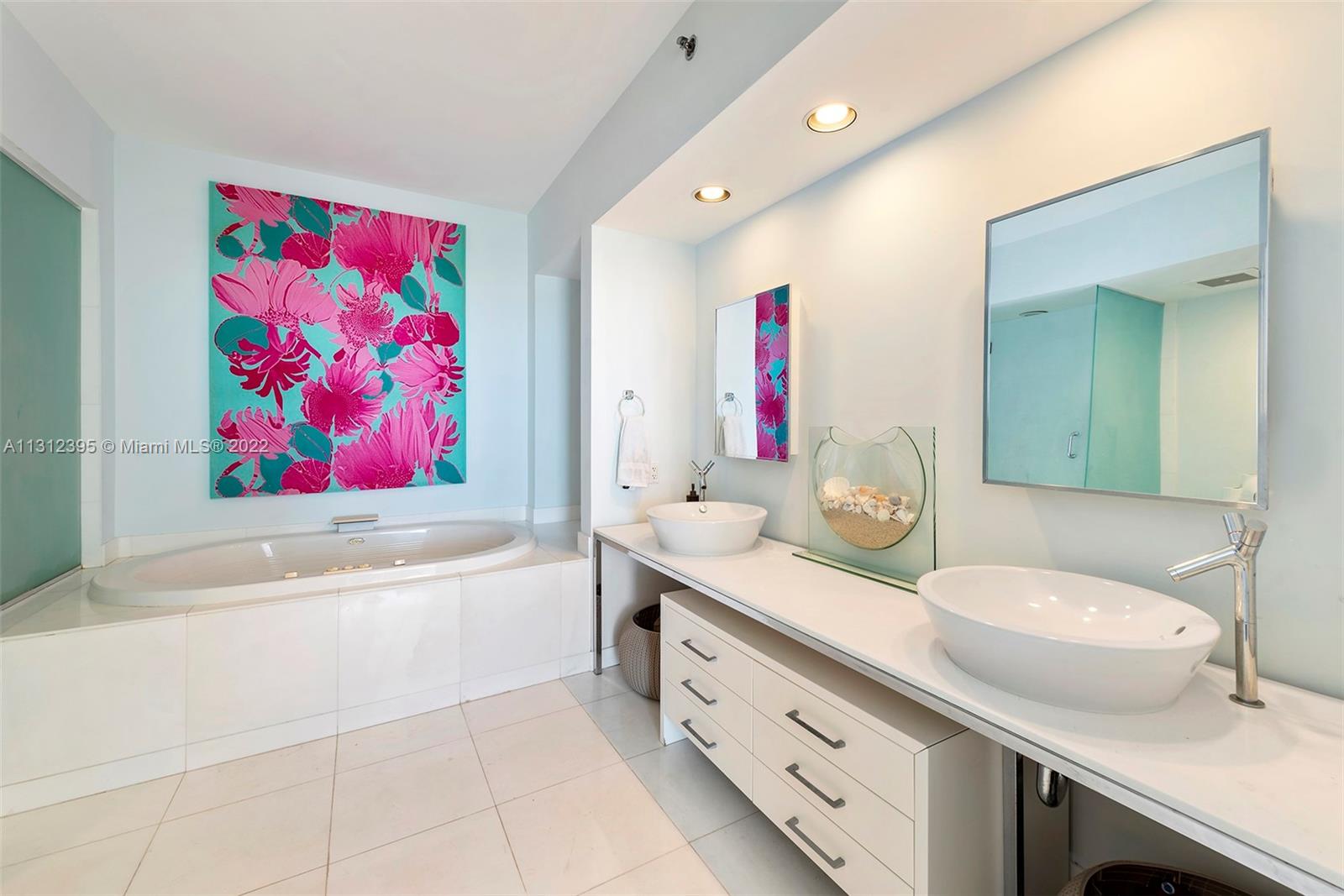 450 Alton Road, Unit 3010 Miami Beach, FL 33139 - Photo 19 of 66 a spacious bathroom with a granite countertop tub sink and mirror