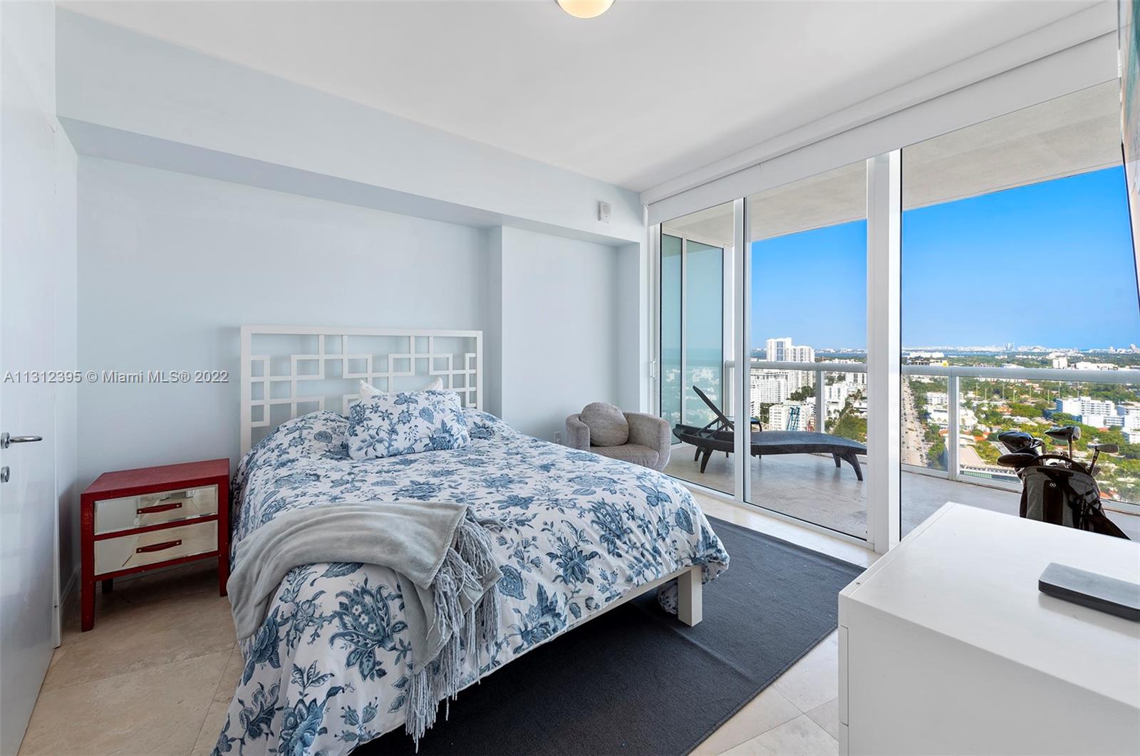 450 Alton Road, Unit 3010 Miami Beach, FL 33139 - Photo 31 of 66 a bed sitting in a bedroom next to a window with balcony