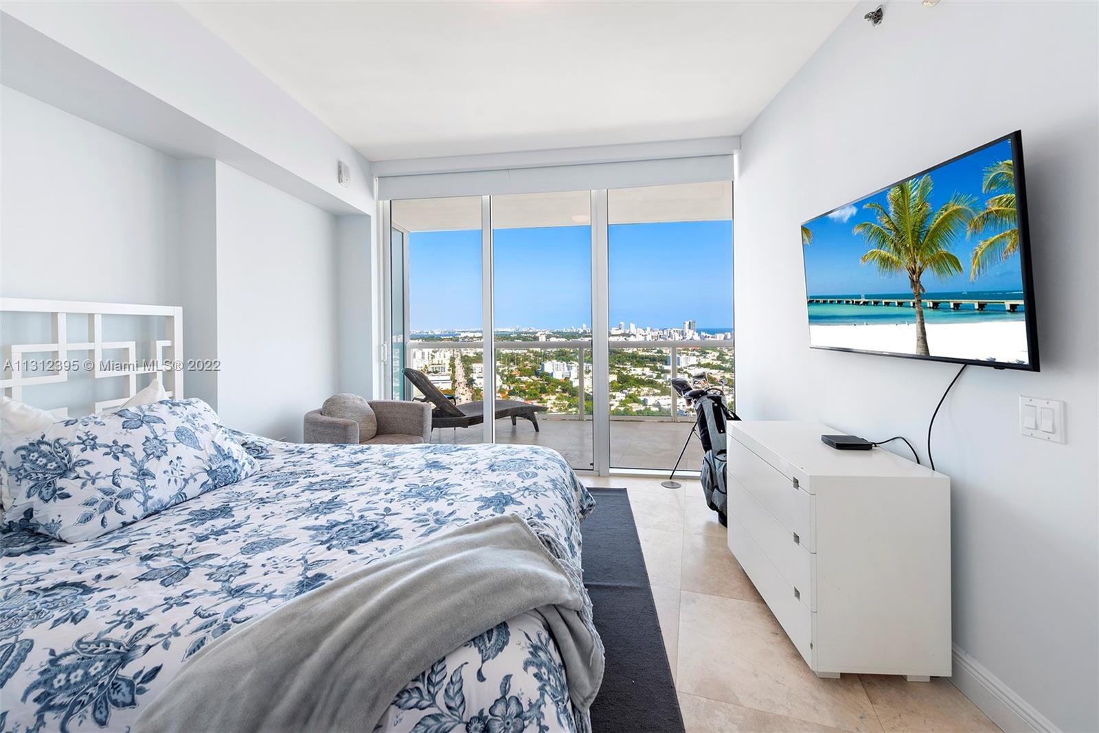 450 Alton Road, Unit 3010 Miami Beach, FL 33139 - Photo 32 of 66 a bedroom with a bed and a dresser
